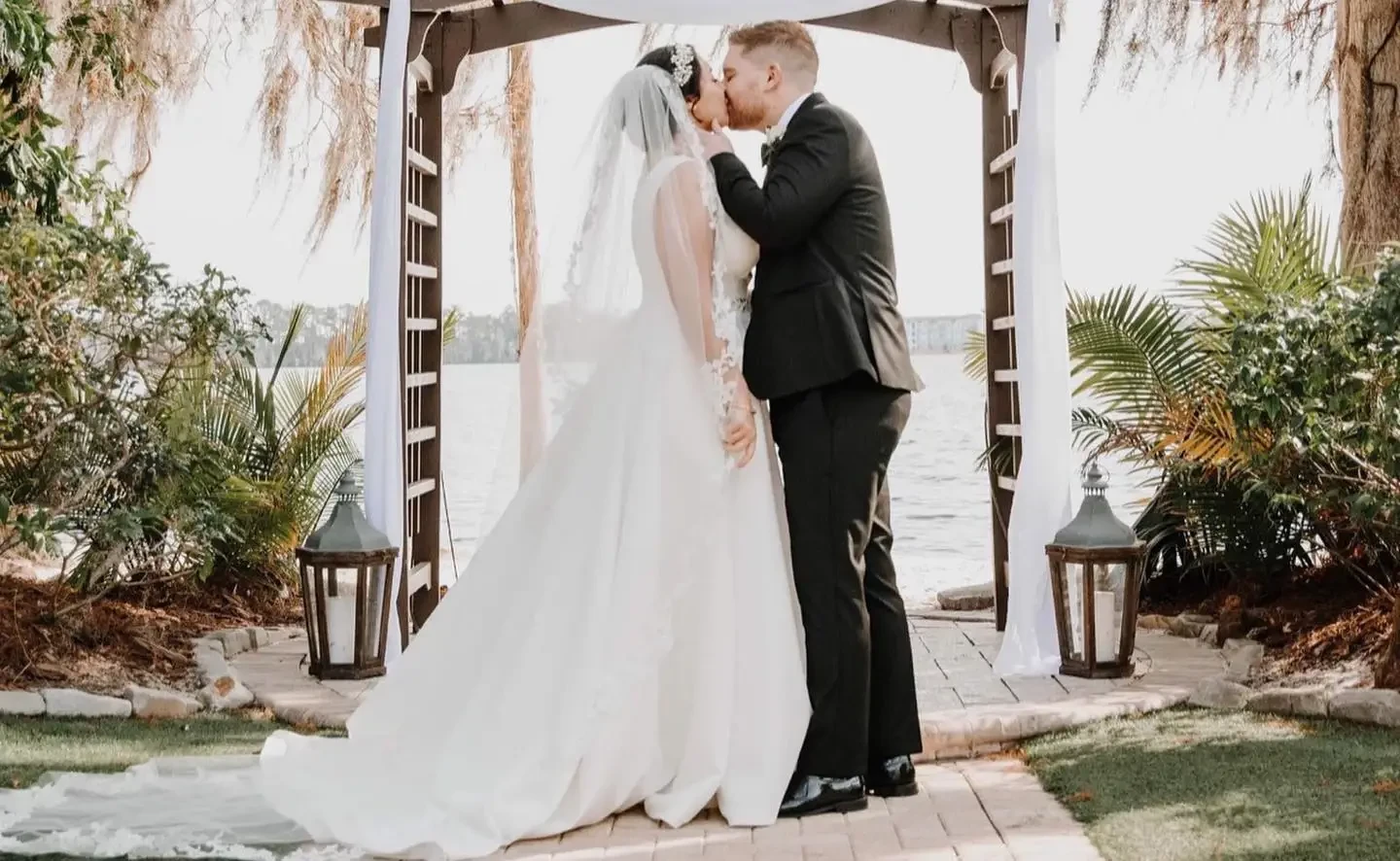 Сouple wearing a white gown and a gray suit