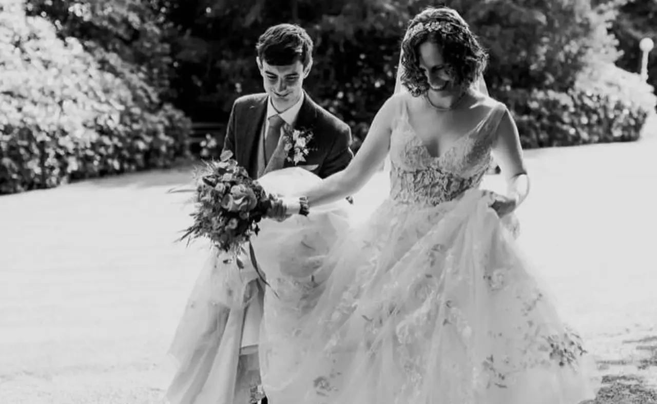 Сouple wearing a white gown and a gray suit