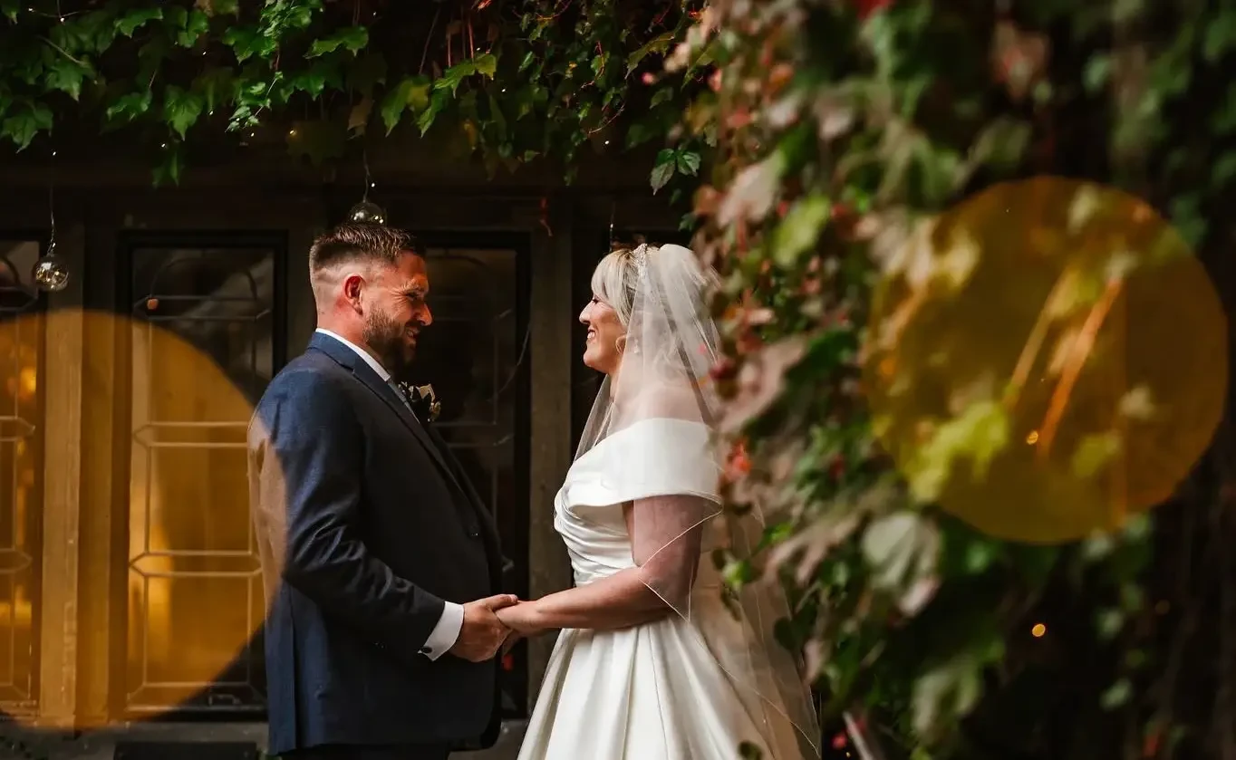 Сouple wearing a white gown and a gray suit